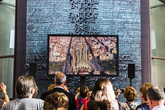 Visitors watching a video of the construction of the Sagrada Familia