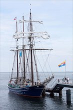 The three-masted traditional rig sailing ship Santa Barbara Anna moored at the pier in the seaside resort of Heringsdorf