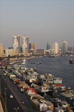 Views over Dubai Creek with traditional wooden boats known as dhow