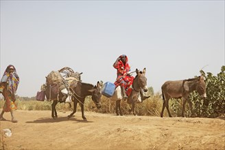 Choa nomads with donkeys at Maga Dam