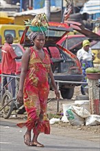 Market woman carrying pineapple on her head