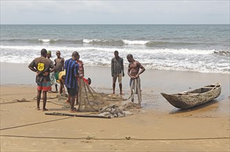 Fishermen with nets on the beach