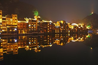 Illuminated houses on the Wuyang River at night
