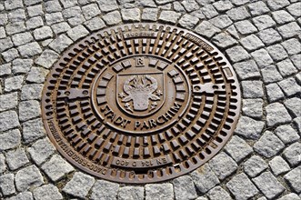 Man-hole cover with inscription