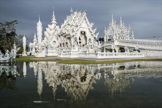 Wat Rong Khun temple or The White Wat with reflection