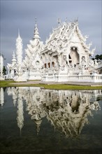 Wat Rong Khun temple or The White Wat with reflection