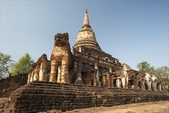 Laterite chedi with destroyed elephant statues