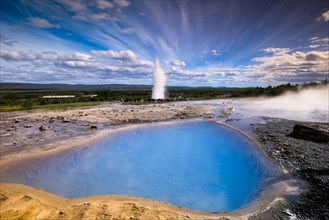 Tourists watching the Strokkur geyser