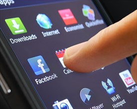 Icon of a smartphone app being selected by a finger