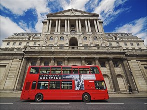 Red double-decker bus in front of The Bank of England building