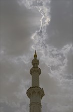 Dark clouds above one of the four minarets of Sheikh Zayed Grand Mosque