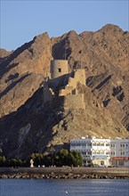 The corniche of Muttrah and the rocky mountains that surround the city at back