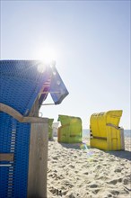 Colourful roofed wicker beach chairs