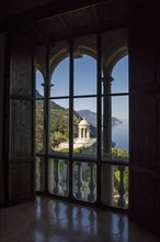 View through arched windows of the park and the coastline