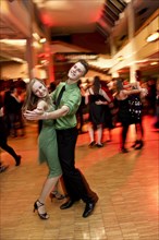 Young couple dancing at the prom of a dance school