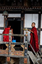 Monks on the site of the monastery of the castle fortress of Trongsa Dzong