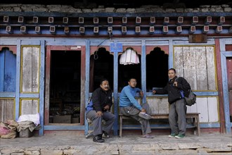 Men outside a shop in the town centre of Mongar