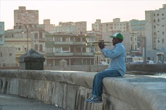 A man playing the trumpet at the Malecon