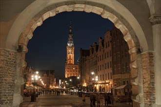 View through Green Gate or Brama Zielona towards the houses on Long Market or Dlugi Targ and the clock tower of Main Town Hall
