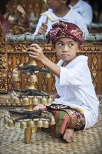 The youngest member of a gamelan orchestra at an event