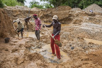 Workers digging at a diamond mine in the jungle