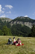 Hiker lying on the Raschoetz alp
