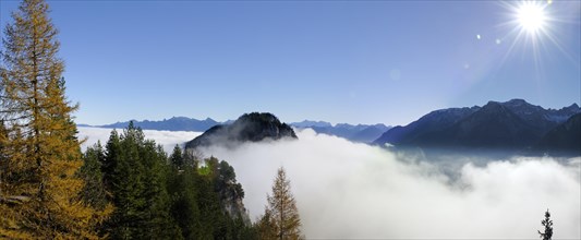 View from the ruins of Falkenstein Castle over the mist-covered Vilser Tal or Vils Valley and Zwoelferkogel mountain near Fuessen