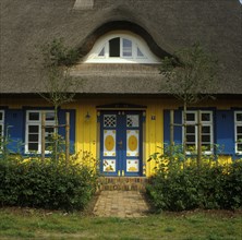 Colourful house with thatched roof