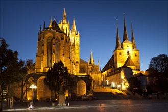 The illuminated Cathedral of St. Mary and St. Severi Church at dusk