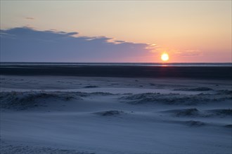 Sunset over the sand dunes on the Nordstrand beach