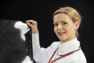 Young female doctor holding an X-ray