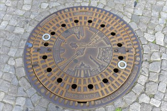 Berlin landmarks depicted on a manhole cover
