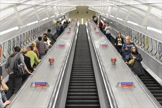 Passengers travelling on escalators at an underground station