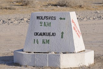 Signpost with directional arrows to Wolfsnes and Okaukuejo