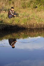 Indigenous man fishing in a pond in the community of Mbya-Guarani Indians