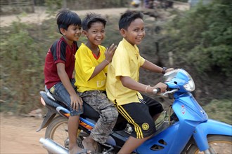 Three boys on a motorcycle