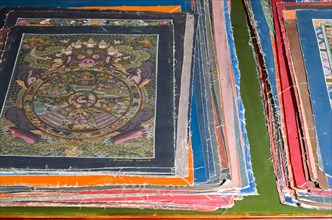 Pile of small Thangkas for sale in one of the art schools near Boudnath Stupa