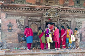 Women queuing to make offerings at a temple on Patan Durbar Square