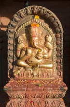Ganesha shrine with brass relief