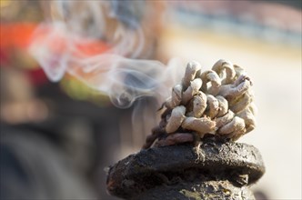 Incense burning in front of a Ganesha shrine