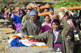 People carrying tibetean prayer books