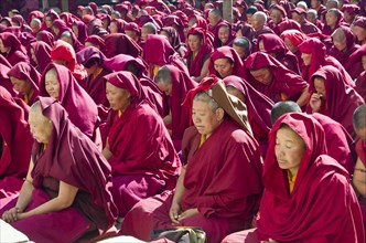 Many nuns wearing red cloths listening the teachings of Taklung Tsetru Rinpoche in the backyard of Junbesi Gompa