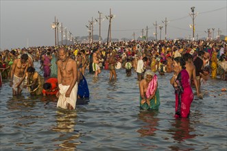 Crowds of people taking a bath in the Sangam