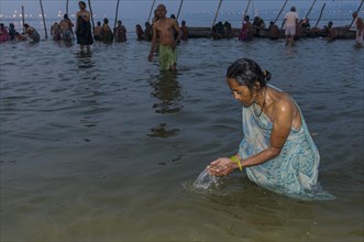 Woman taking a bath in the Sangam