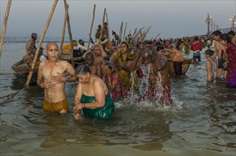 Crowds of people taking a bath in the Sangam
