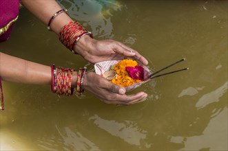 Woman offering flowers at the Sangam