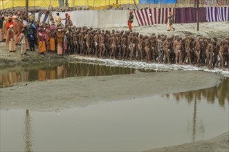 Sadhus walking to the river Ganges after shaving their heads as part of their initiation