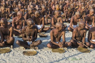 Taking their first meal in their new lives as part of the initiation of new sadhus