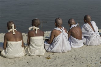 Group of new Jain nuns sitting at the banks of the river Ganges during their initiation