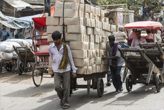 Men transporting goods on a hand cart on Khari Baoli Road